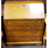 A George III oak bureau, fall front enclosing fitted interior over four graduated drawers,