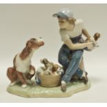 Lladro - A Lladro figure group of a boy with dog and puppies, stamped 5376,