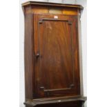 A George III mahogany corner cupboard