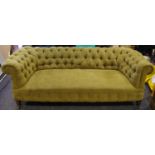 A Victorian Chesterfield settee, olive green upholstery.