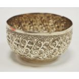 A white metal Indian bowl repoussé decoration of foliate scrolled panels 79g gross