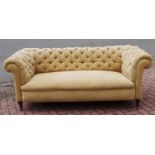 A Victorian Chesterfield settee, beige, patterned upholstery.