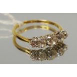 A yellow metal five stone ring claw set with graduated round diamonds approx 1.2cts total, size Q 2.