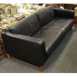 A black leather executive office sofa.