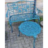 A cast metal two seat garden bench; a cast metal circular garden low table.