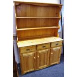 A pine dresser, shaped uprights and two shelves to top,