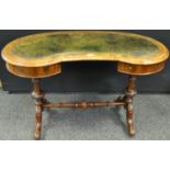 A Victorian walnut kidney shaped desk, tooled leather inlaid surface, two drawers to frieze,