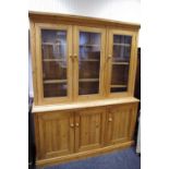 A pine dresser, three glazed doors to top,