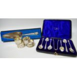 A cased silver set of six teaspoons and sugar nips; silver napkin rings,