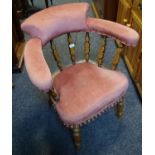 An early 20th century elm over stuffed captains chair c.