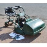 An Atco Royale B30E ride-on lawn mower with attachments