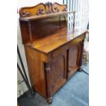 A Victorian flame mahogany chiffonier, shaped cresting pediment, shelf and turned supports to top,