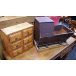 Furniture- a modern six section collectors cabinet; early 20th century cradle; two trays;