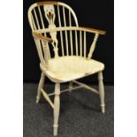 A painted yew Windsor chair, pierced and shaped splat, saddle seat, turned H stretcher.