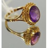 A 9ct gold ring set with an oval amethyst, size L1/2, 3.