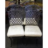 A set of four tubular steel dining chairs, metal lattice work back, padded seat,