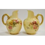 A pair of Royal Worcester blush ivory globular jugs with ribbed gilt handles
