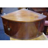 A George III mahogany table top corner cabinet