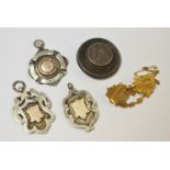 Three silver and gilt fobs 33.5g gross; silver target brooch 12g gross; a 9ct gold Mexpah brooch 3.