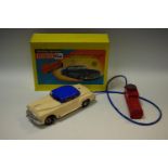 A Marx (British) battery operated electric car, cream body, blue roof and silver trim,