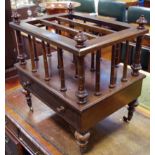 A rosewood Canterbury, turned finials and columns, single drawer to base, turned legs,