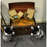 An early 20th century metal trunk; another smaller; a pair of stage lamps;