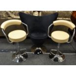 A pair of contemporary breakfast bar stool in ivory faux leather upholstery;