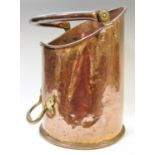 A cylindrical copper coal scuttle