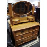 An Arts and Crafts oak dressing chest, oval mirror and two short drawers to superstructure,