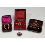 A 15ct gold brooch as a sword and a laurel leaf, 4g, boxed; a 9ct gold bar brooch, set with an