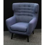 A retro style wingback armchair, shallow button back, tapered cylindrical legs, 104.5cm high