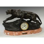 An Art Deco clock, Lion on the Lookout, after Boffi, rouge marble base, 58cm wide