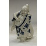 A Japanese porcelain figure, of Hotai, smiling, carrying his sack, 21cm high, Meiji period