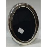 An Elizabeth II silver oval easel photograph frame, Sheffield 1992