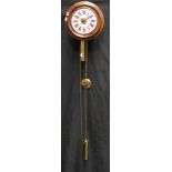 A circular mahohany postman's alarm wall clock, white dial with pink chapter ring, Roman numerals,