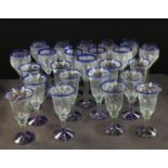 A set of twelve blue flashed wine glasses; another set similar