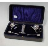 A silver three piece condiment set, Birmingham, pair of spoons en suite, cased