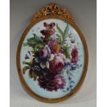 A Lynton porcelain oval plaque, painted by Stefan Nowacki, signed, with a still life of English