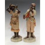 A pair of 19th century Austrian terracotta figures, of Nubian musicians, bronzed flesh, their native