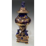 A 19th century French earthenware vase and cover, glazed in Mazarin blue and richly decorated in