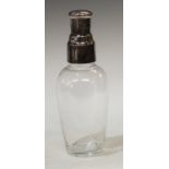 An early 20th century clear glass cocktail shaker, electroplated cover, 26cm