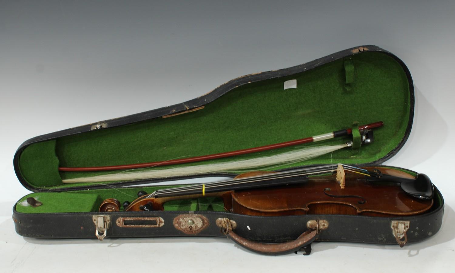 A 19th century German 3/4 size violin, the two-piece back 33.5cm long excluding button, outlined