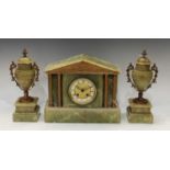 A late 19th century gilt metal mounted onyx clock garniture, architectural form, flanked by