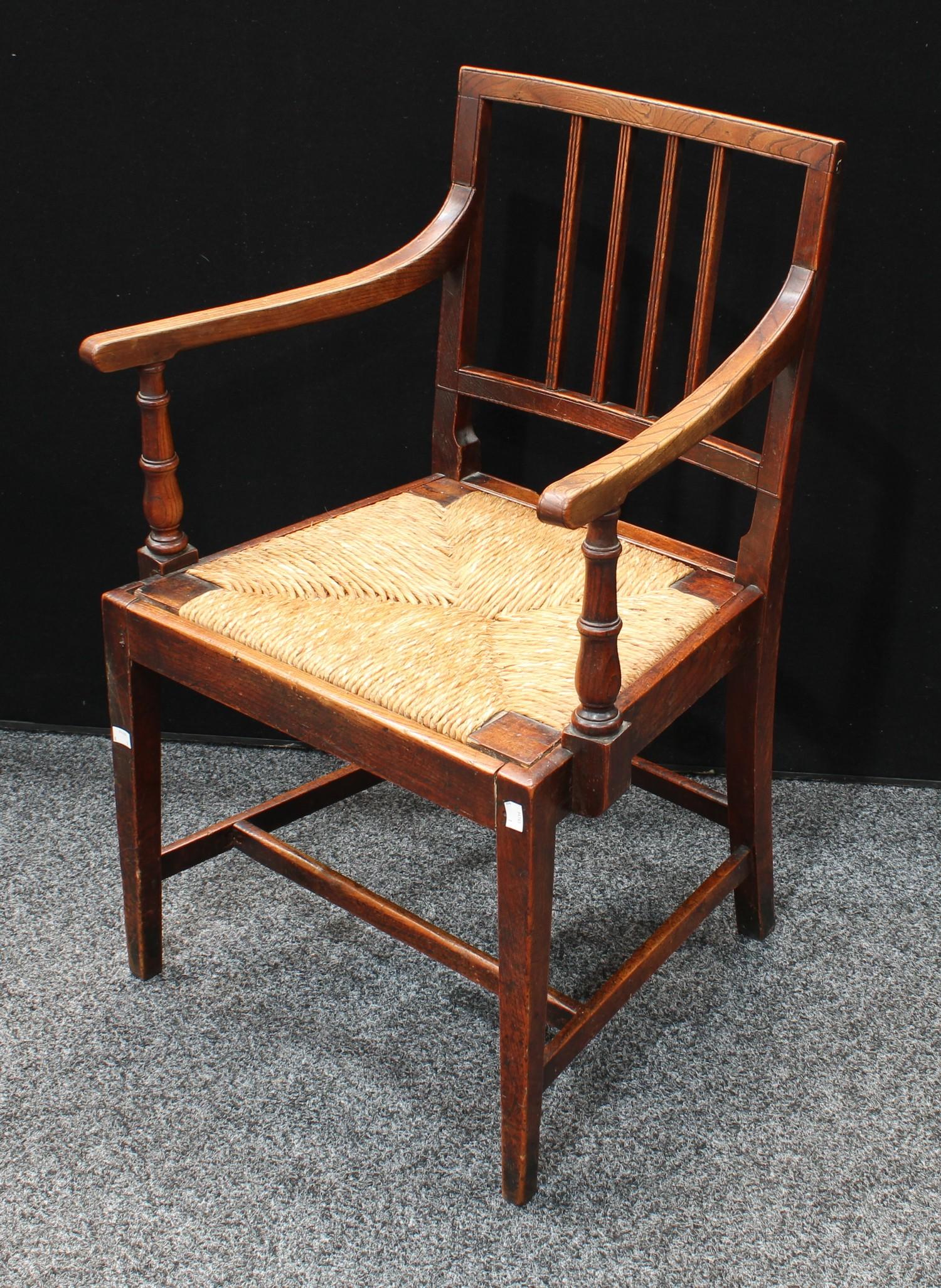 A 'George III' Country House elm and mahogany open armchair, drop-in rush seat, tapered square legs,