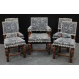 A set of five early/mid 20th century oak dining chairs. stuffed over upholstery, carved supports,