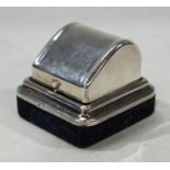 A silver dome top ring box