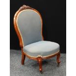 A Victorian Walnut nursing chair, stuffed over upholstery,brass casters. 90cm high