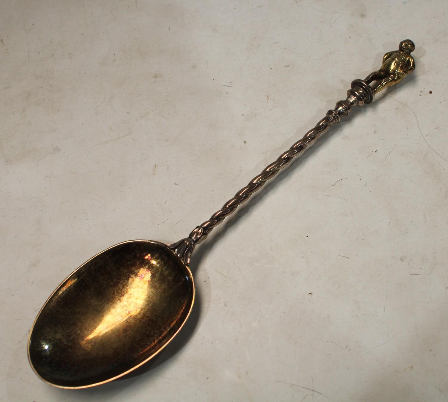 A mid-Victorian parcel-gilt silver 'Apostle' table spoon, the figural finial cast as a rotund