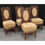 A set of four Jacobean style oak dining side chairs, each back pierced and carved with fruiting