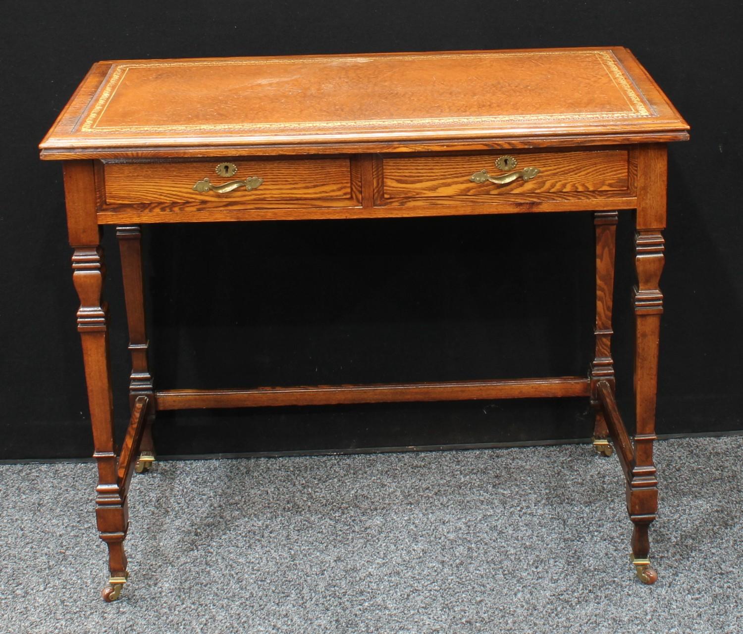 An early 20th century oak writing desk, in the manner of Gillow & Co, moulded rectangular top with